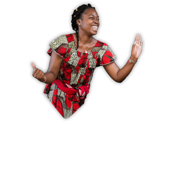  A woman in a striking red and black dress leaps joyfully into the air, showcasing her vibrant outfit and dynamic movement.