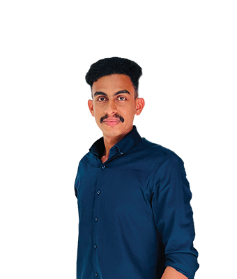 A young man with a styled mustache and dark hair is wearing a dark blue button-down shirt. He is posed in front of a white background, giving a confident and slight smile.